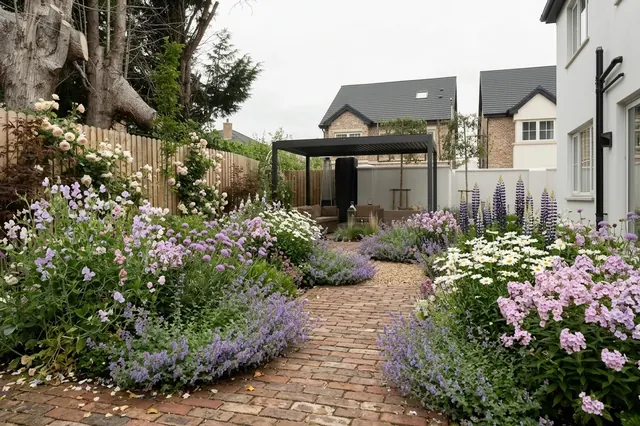 AI generated cottage redesign of the same view: a large pale porcelain slab patio beside a small lawn with a timber fence, a pergola and neighbouring houses, replanted.